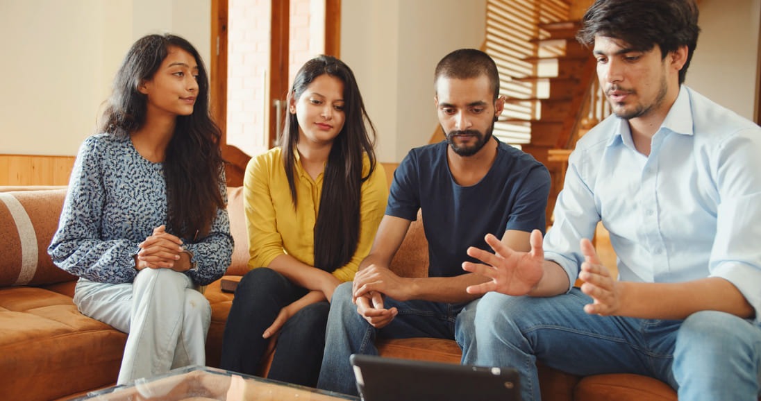 shot-four-young-south-asian-friends-india-sitting-indoors-looking-tablet (2)